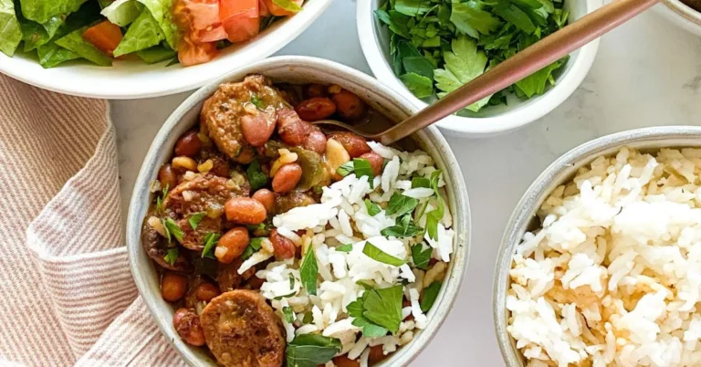 "A hearty bowl of red beans and rice garnished with fresh parsley, served with a side of cornbread."