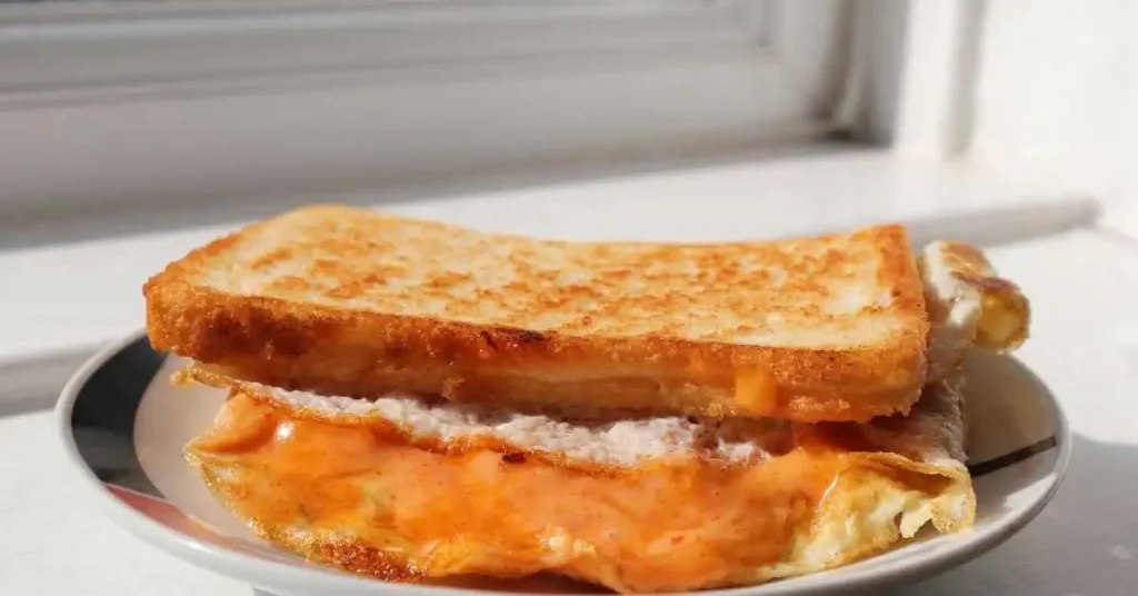 Stacked French toast slices with butter, maple syrup.