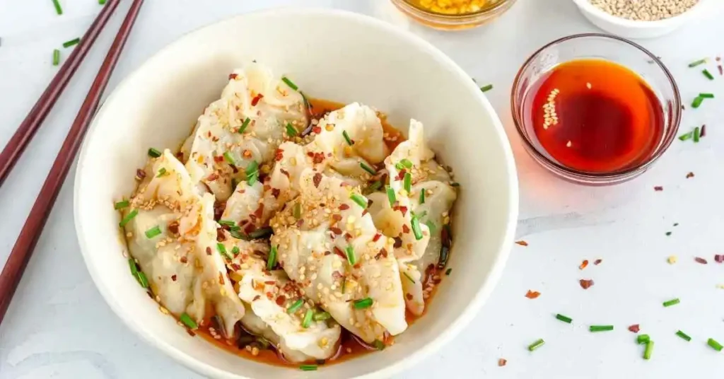 A close-up of Instant Pot Chicken and Dumplings served in a white bowl.