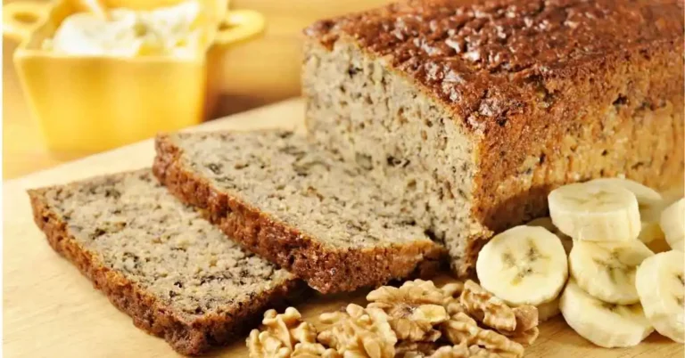 Freshly baked banana bread sliced on a wooden board