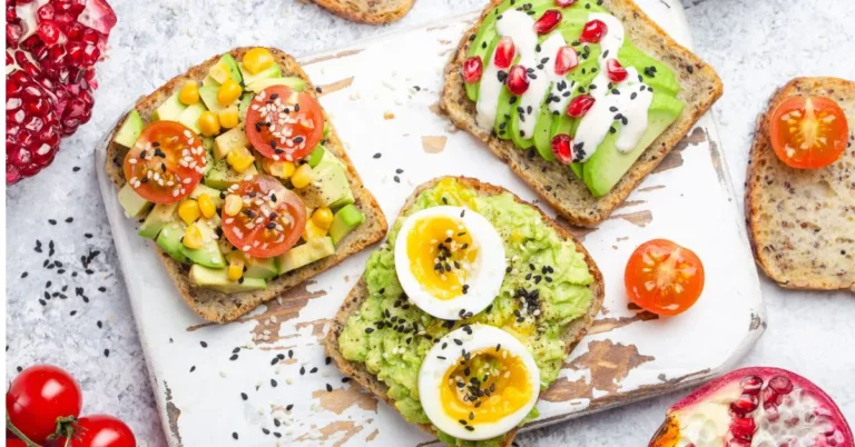 A delicious avocado toast topped with a sprinkle of salt, pepper, and red chili flakes on toasted bread.