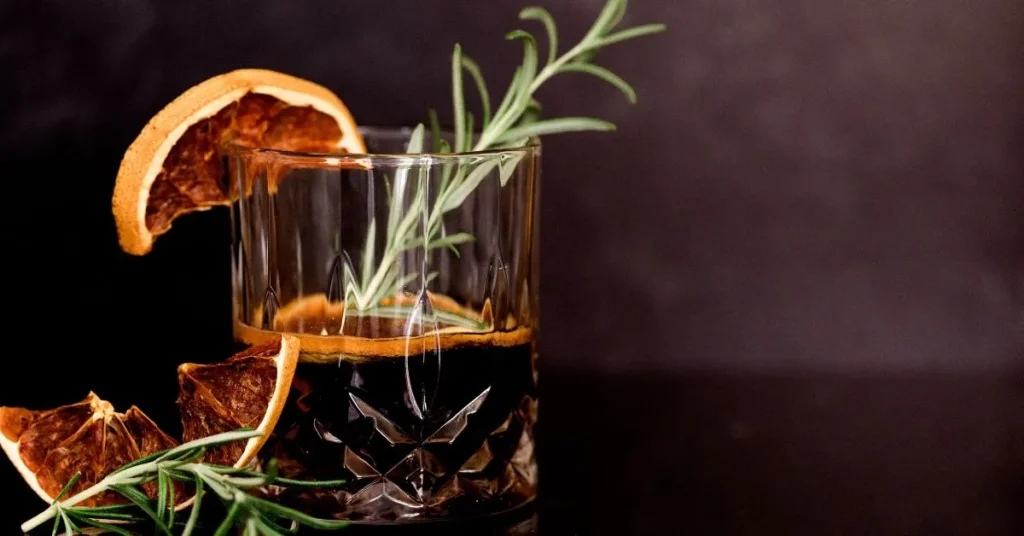 A classic Jager Bomb cocktail served in a tall glass with a shot glass on the side.