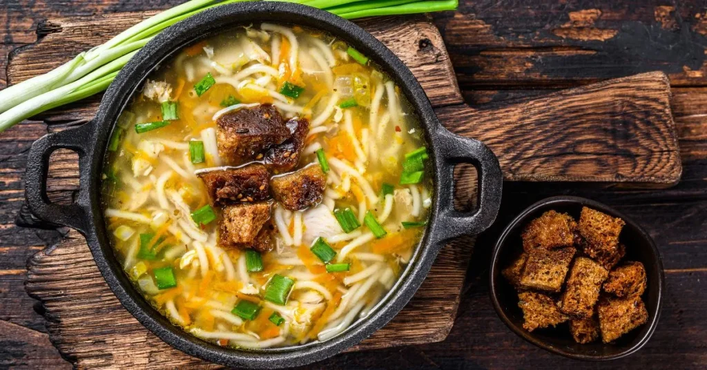 A vibrant bowl of the best chickpea noodle soup with tender pasta, carrots, celery, and a flavorful broth.