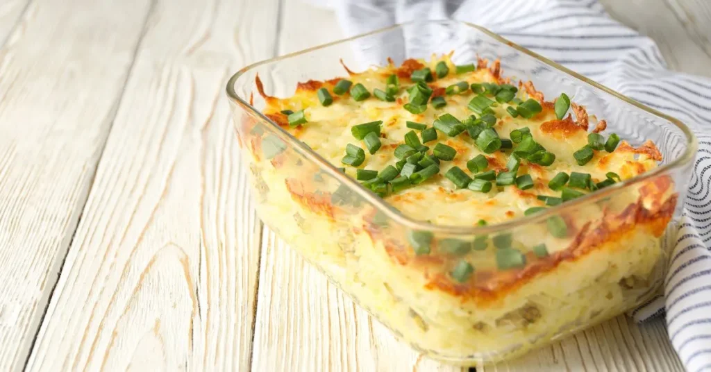 A golden-brown pineapple casserole with a crispy topping served in a baking dish.