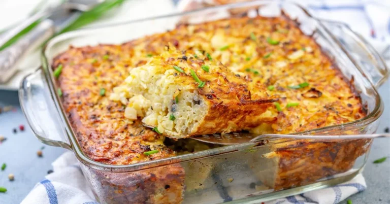 Pineapple casserole topped with golden-brown buttery crackers and melted cheese in a baking dish.