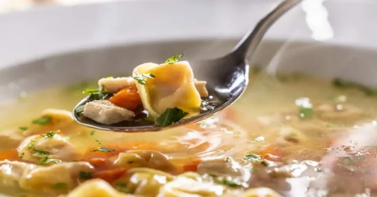 Bowl of Slow Cooker Chicken Tortilla Soup topped with avocado, and tortilla strips.