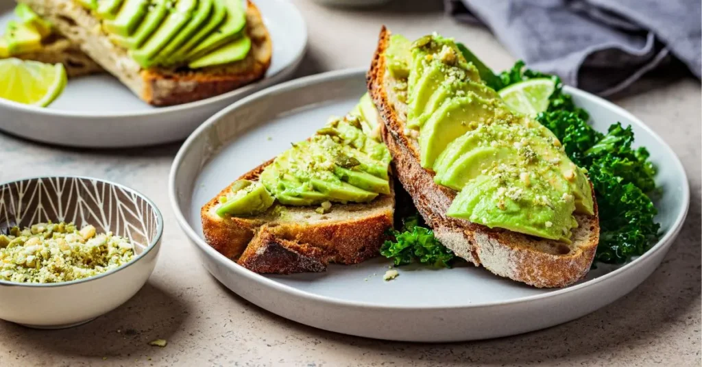 A delicious avocado toast with mashed avocado spread on a toasted slice of bread, garnished.