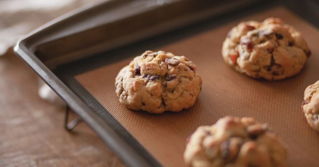 Letting cake mix cookies cool on a baking sheet before transferring them to a wire rack.