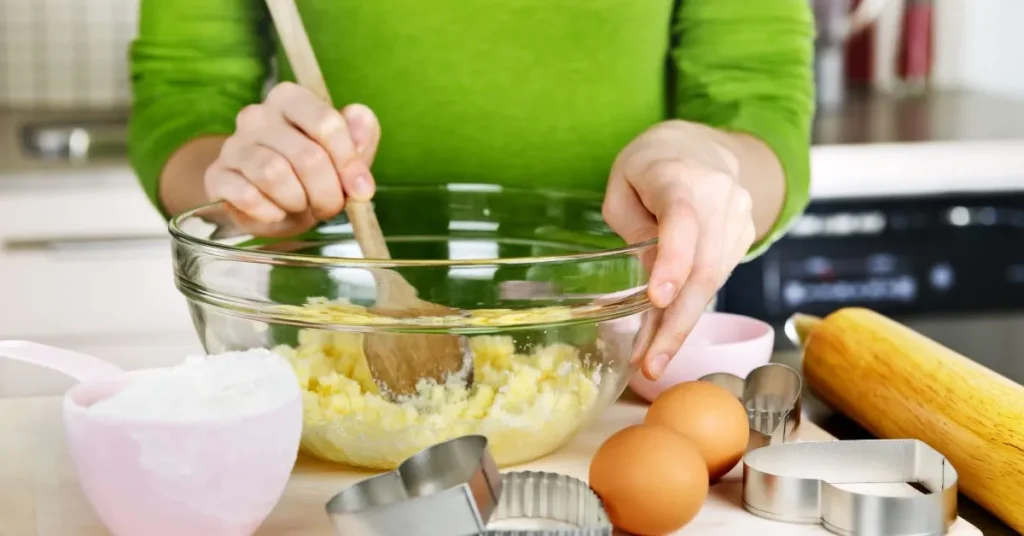 Mixing cake mix, eggs, and butter in a large bowl to make cake mix cookies.