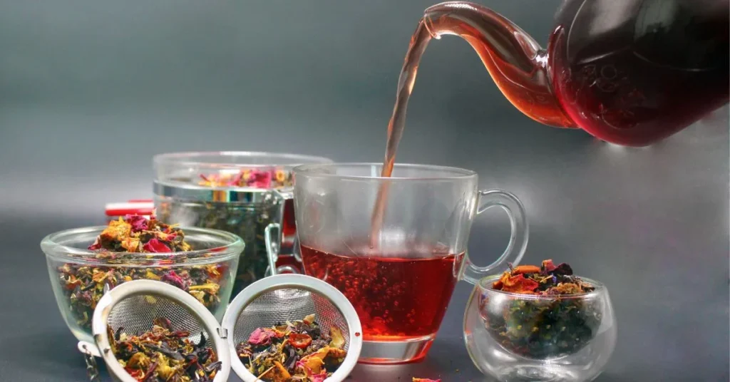 A teacup filled with freshly brewed Throat Coat Tea, surrounded by herbal ingredients like licorice root and slippery elm.