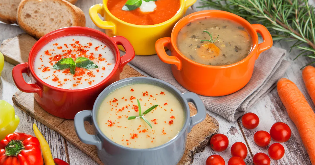 A steaming bowl of Sopa de Pollo with tender chicken, vegetables, and broth, served with fresh cilantro and lime.