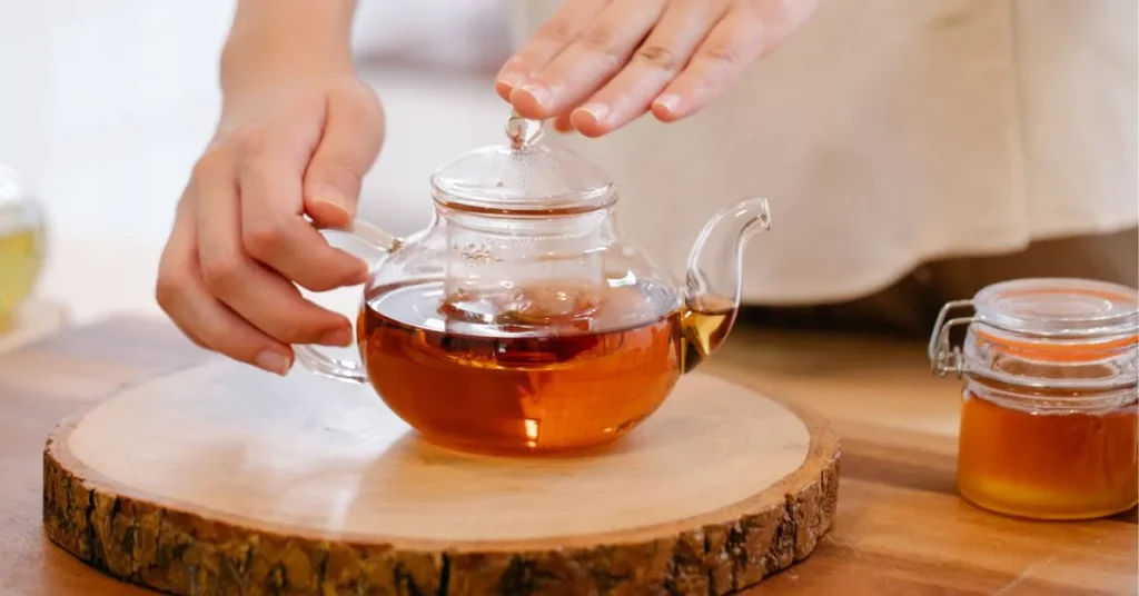 A warm cup of Throat Coat Tea with steam rising, known for its soothing throat benefits.