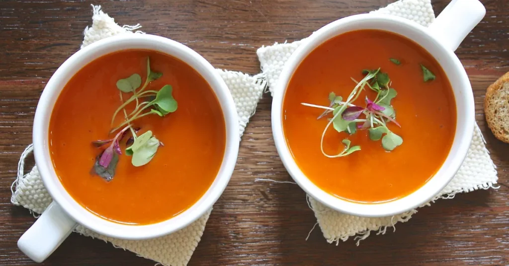 A steaming bowl of Sopa de Pollo, a traditional chicken soup with vegetables, herbs, and rich broth.