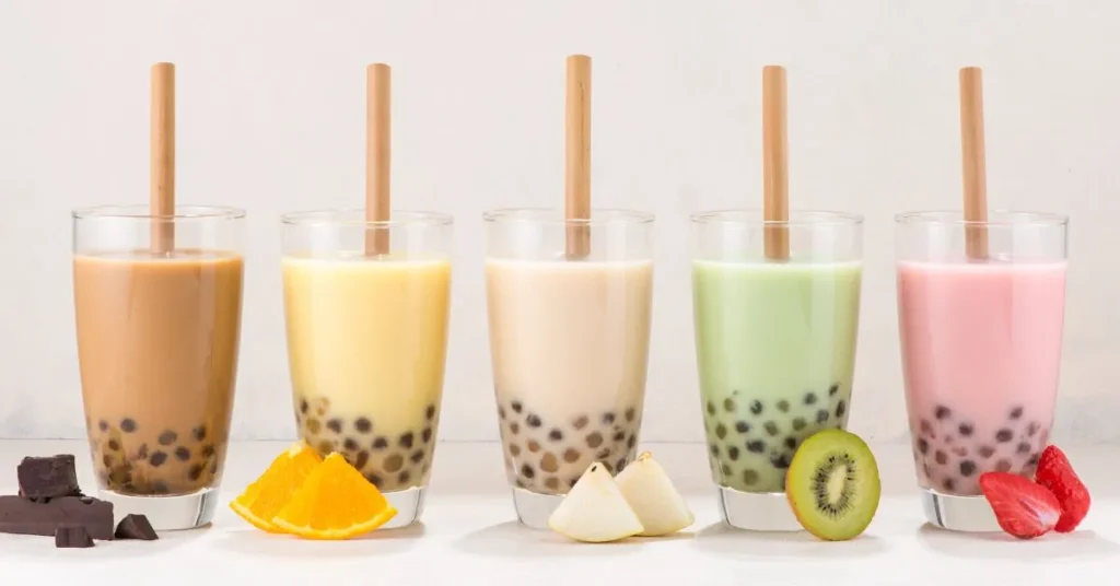 A vibrant cup of bubble tea with chewy tapioca pearls, cream swirling on top.